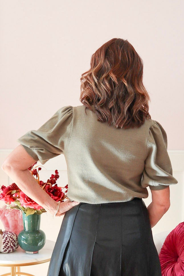 Olive green women's short sleeve sweater. Featuring a feminine bow detail, short puff sleeves and a structured knit. Shop Chloe & Claire.